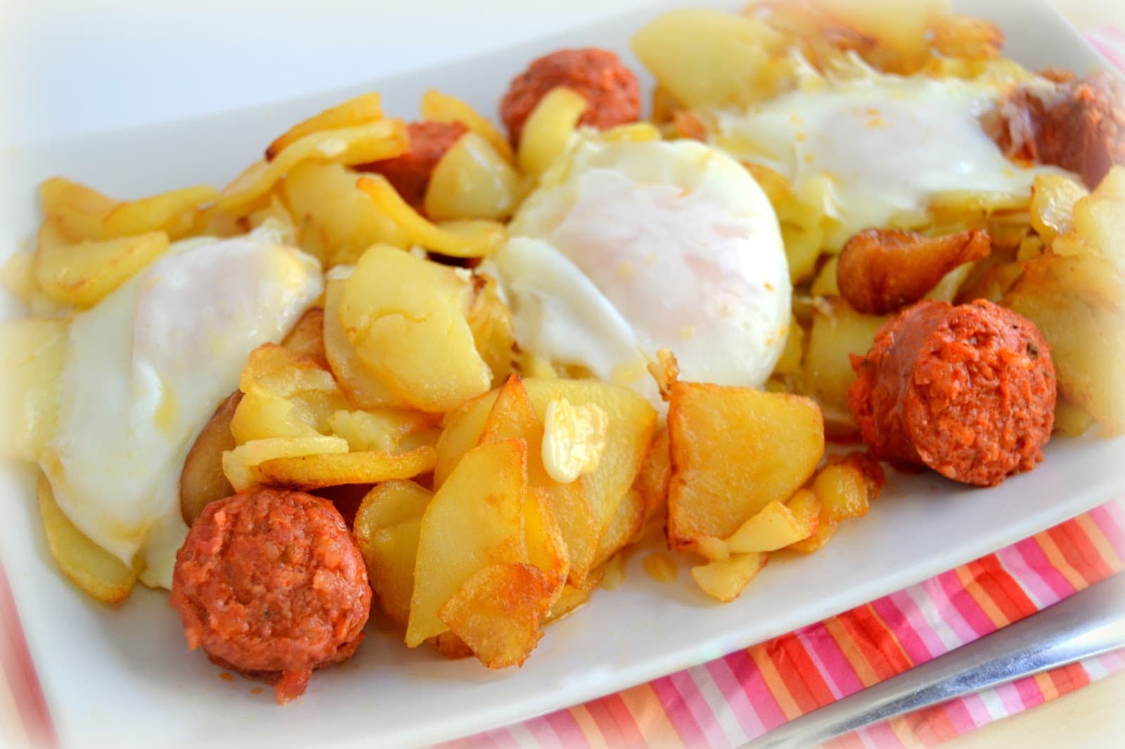 fried eggs with fried chorizo